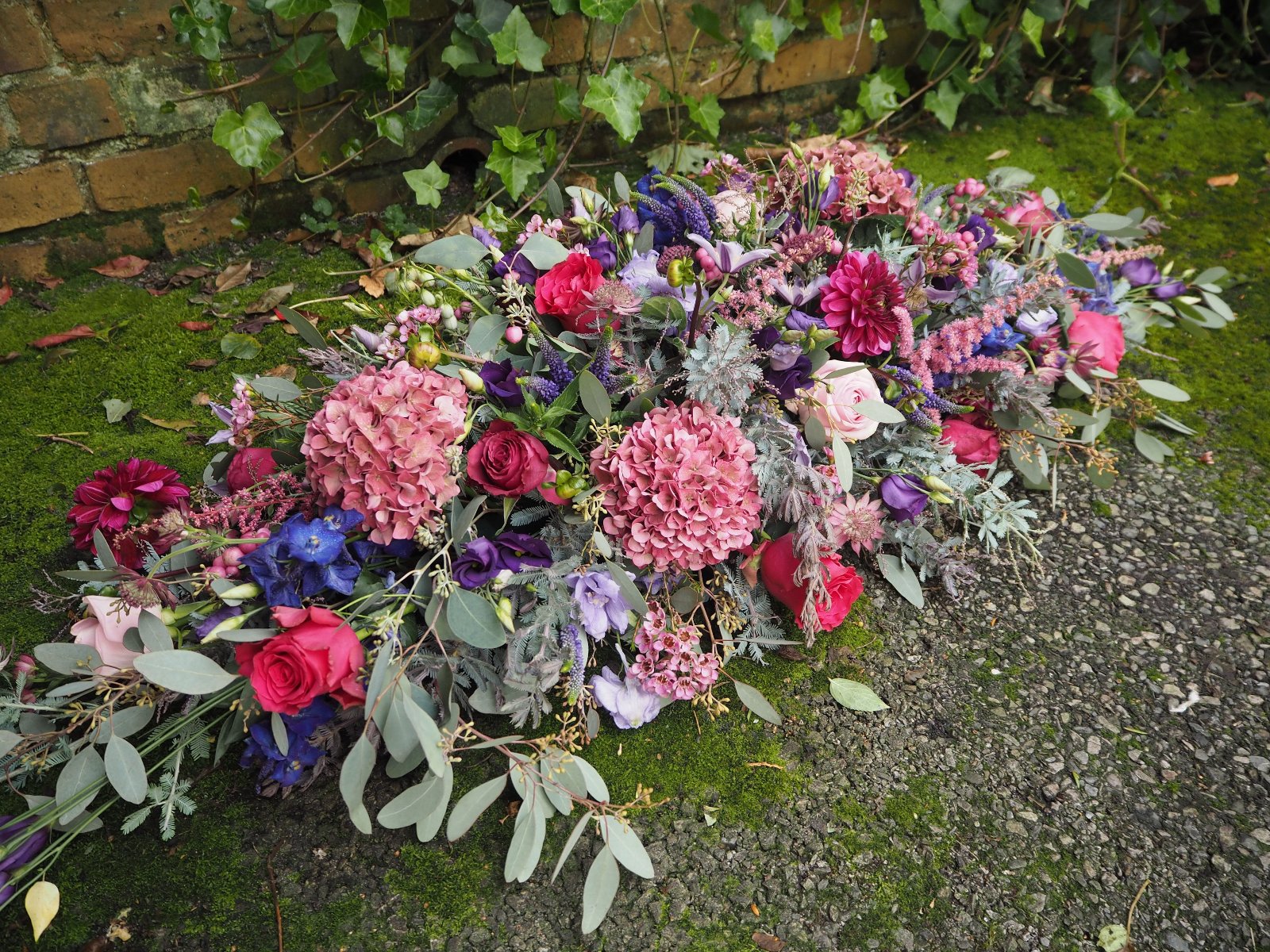 A beautiful Casket Spray for a funeral, full of Pinks, Purples and lilacs