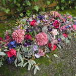 A beautiful Casket Spray for a funeral, full of Pinks, Purples and lilacs