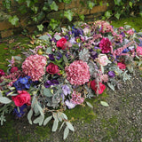 A beautiful Casket Spray for a funeral, full of Pinks, Purples and lilacs